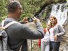 Familie beim Wandern & Fotografieren vor Wasserfall in Hafling